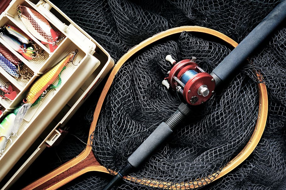 brown fishing net and black fishing rod, fishing lures, fishing box
