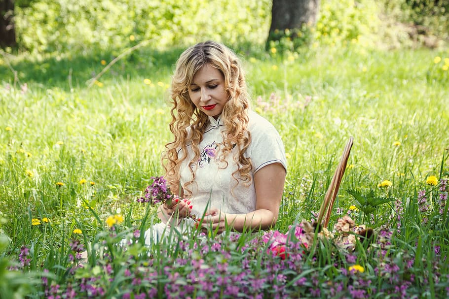 woman sitting on green grass, glade, flowers, basket, girl, nature
