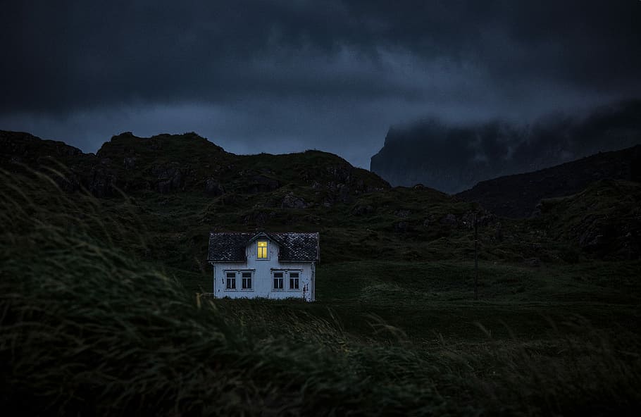 white and brown house on mountain under black clouds, lighted house on mountain during nighttime HD wallpaper
