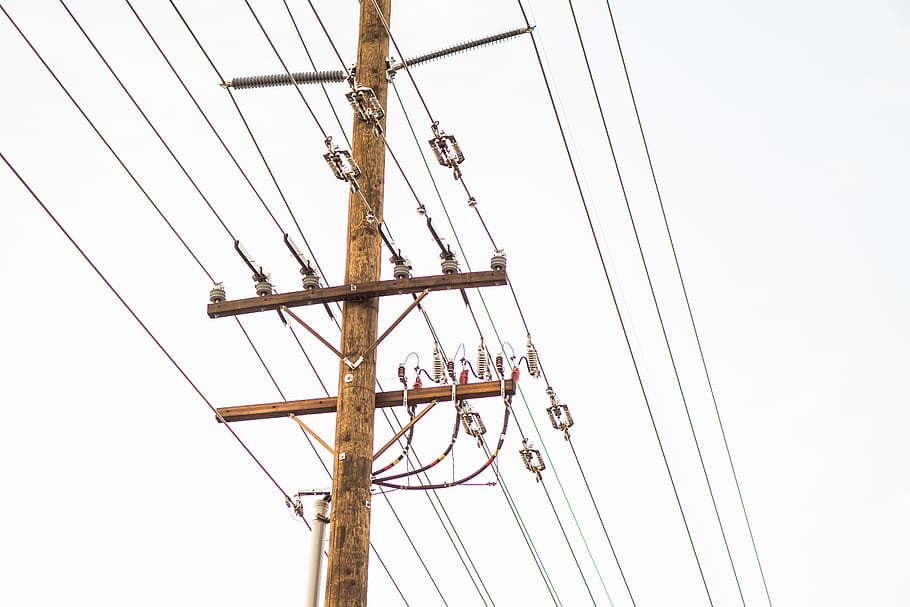 brown transmission tower with cables, low angle photo of brown electric post under white sky HD wallpaper