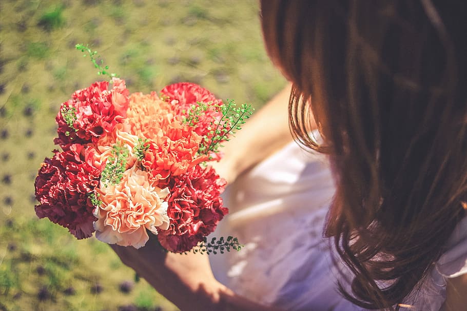woman holding flower bouquet, women, nature, outdoors, females HD wallpaper