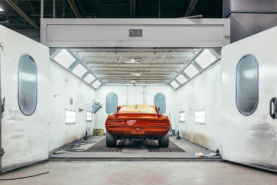 orange car inside a well-lighted open garage, transportation HD wallpaper