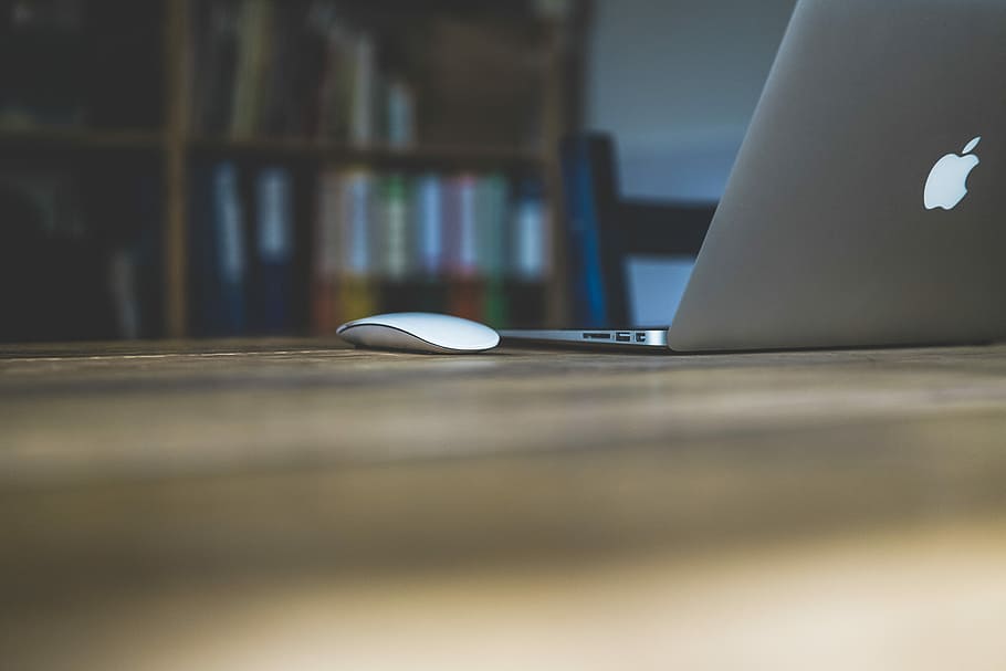 Magic mouse on brown table, MacBook Air beside Apple Magic Mouse on table HD wallpaper