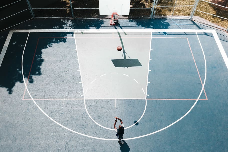 Three points., person playing basketball on a basketball court