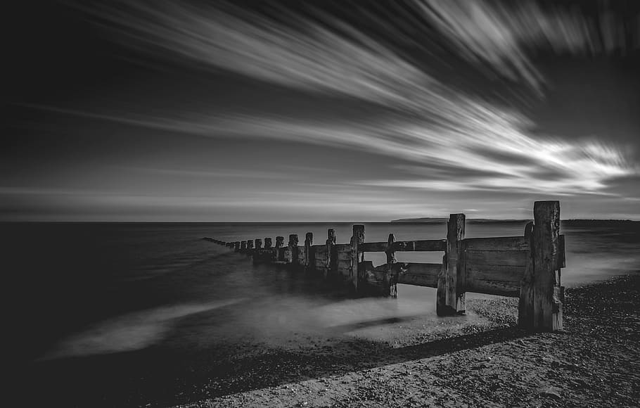 grayscale photo of wooden fence on sand, grayscale photography of brown wooden dock under clouds HD wallpaper