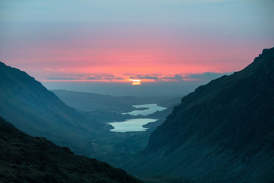 aerial photo of lake during sunset, river between black mountain during sunset HD wallpaper