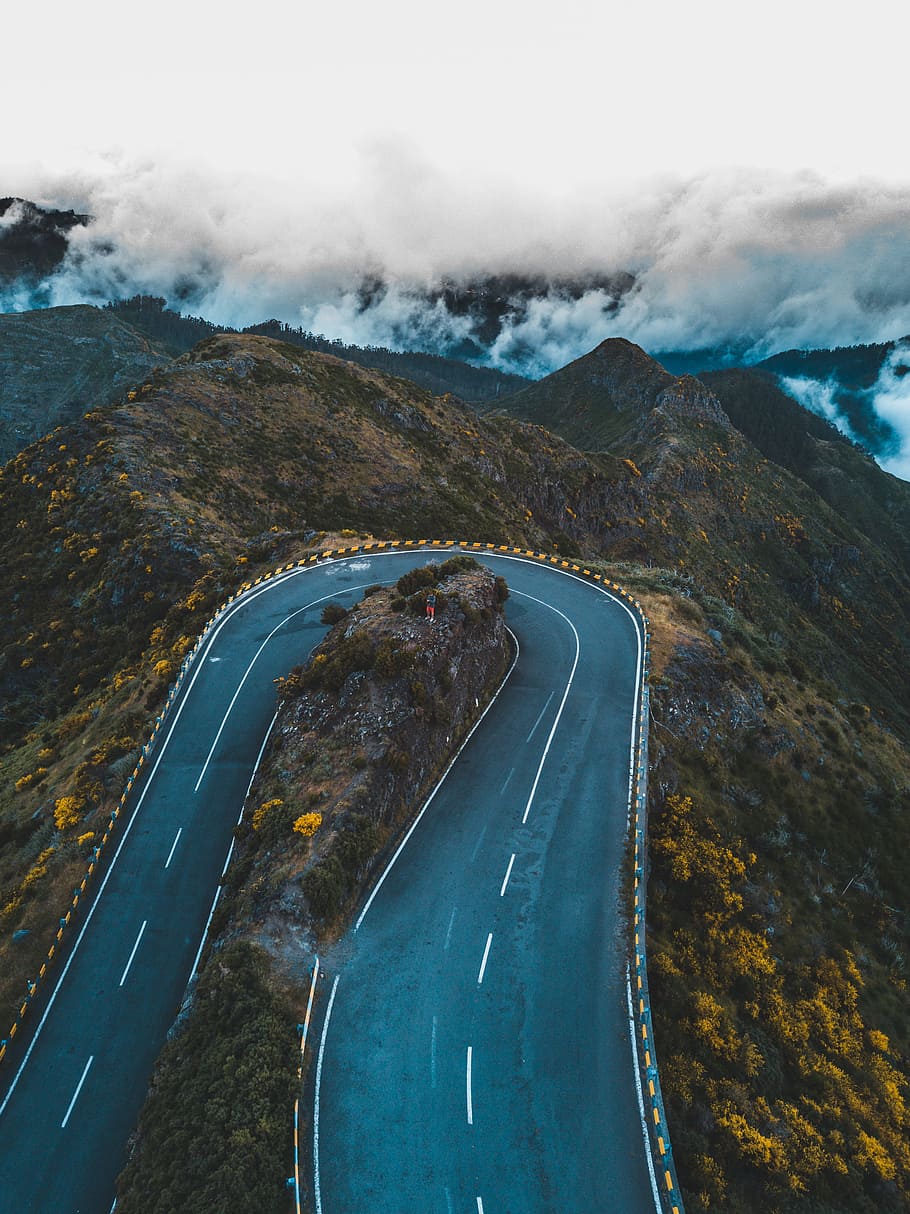 aerial photography of mountain pass under white clouds, bird's eye view of oval road over the mountain HD wallpaper