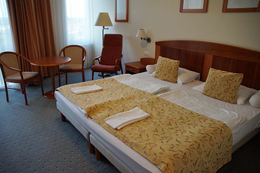 yellow and whote bedspread beside armchairs near window, double bed HD wallpaper