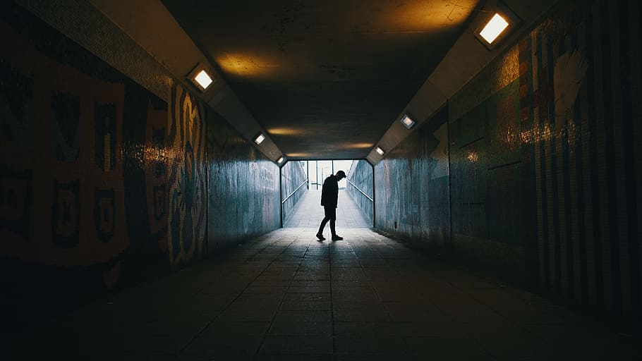 silhouette of a man inside subway, man walking in tunnel, middle