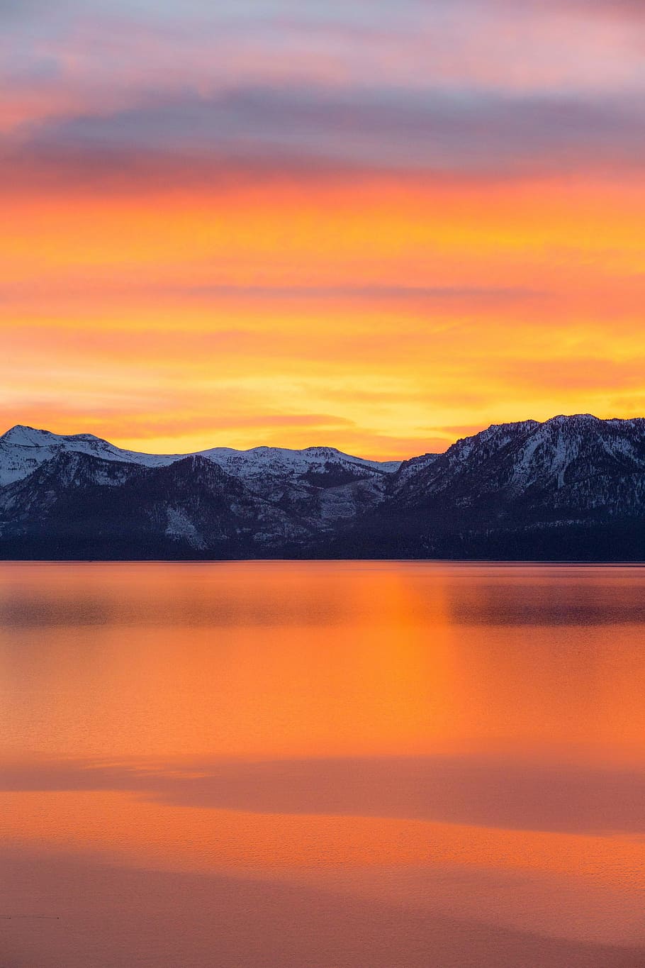 mountains and lake during sunset, panoramic photo of snow-capped mountains beside body of water during golden hour HD wallpaper