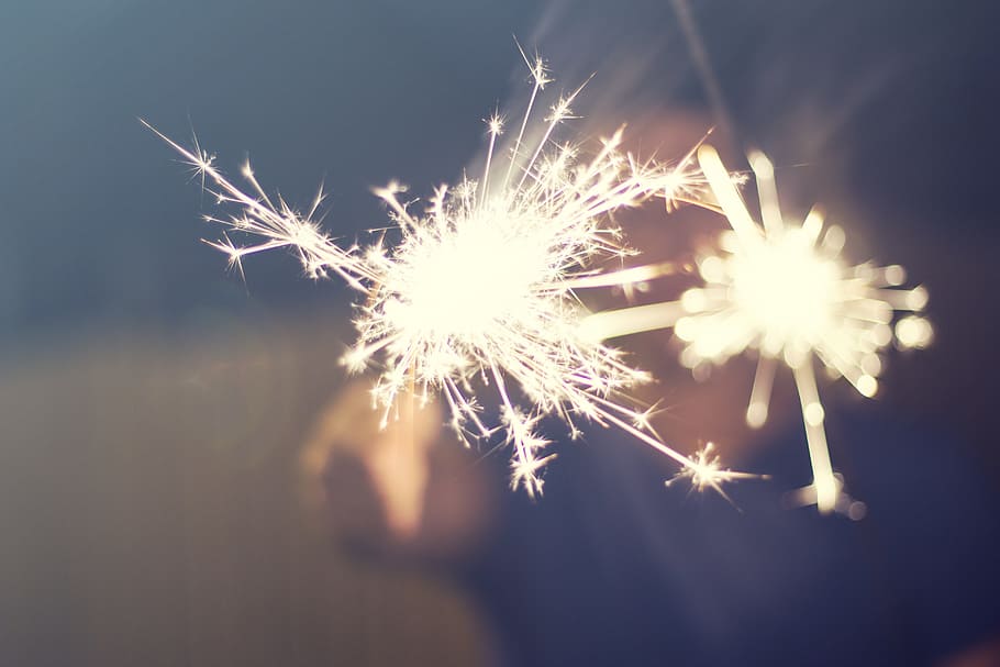 selective focus photo of person holding lighted sparkler, still HD wallpaper