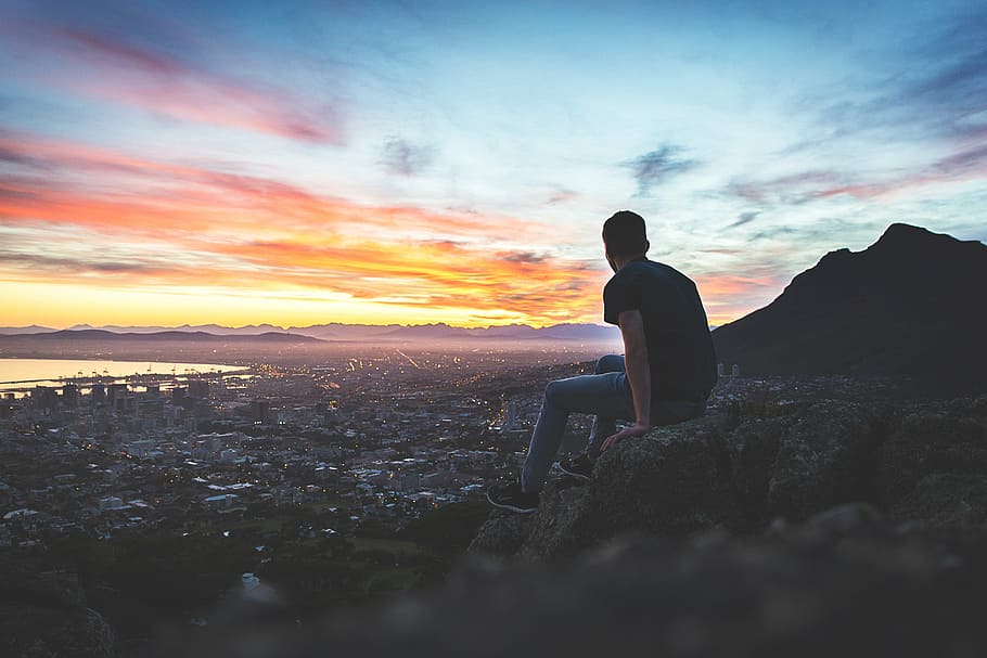 man sitting on rock formation during sunset, view, valley, cliff HD wallpaper