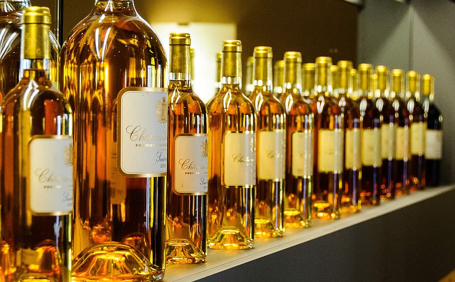 30+ years of Sauternes wines at Chateau Suduiraut, selective focus photography of displayed liquor bottles