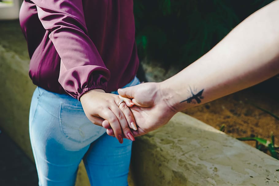 couple holding hands during daytime, man and woman holding hand during daytime HD wallpaper