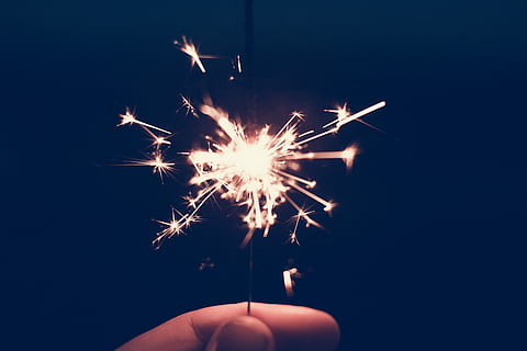 Sparcle in the night, person holding lighted fire cracker, spark HD wallpaper