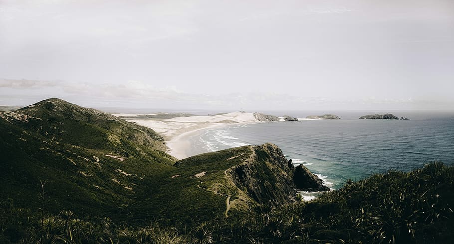 aerial view of ocean, aerial photo of body of water near mountain HD wallpaper