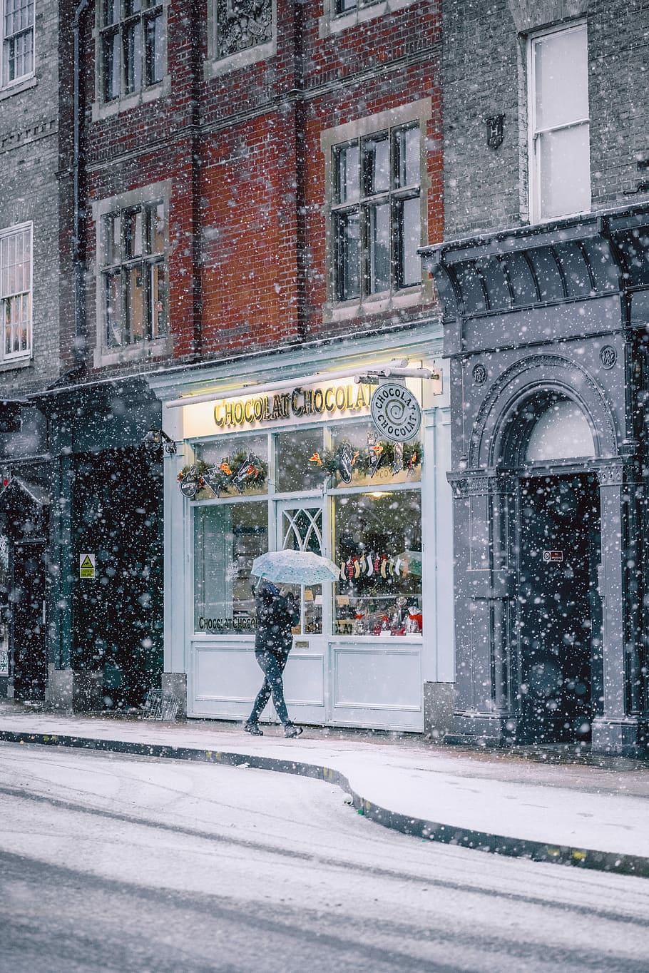 parson walking near cafe during winter, person holding umbrella while walking HD wallpaper