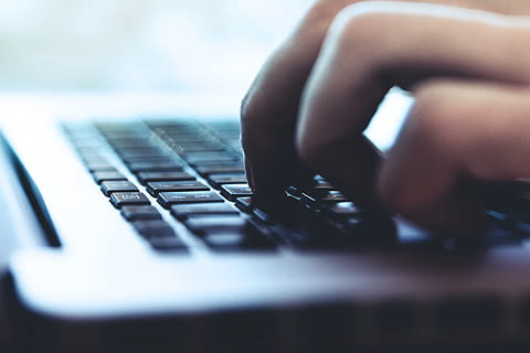 Closeup shot of a person typing on a laptop computer keyboard HD wallpaper