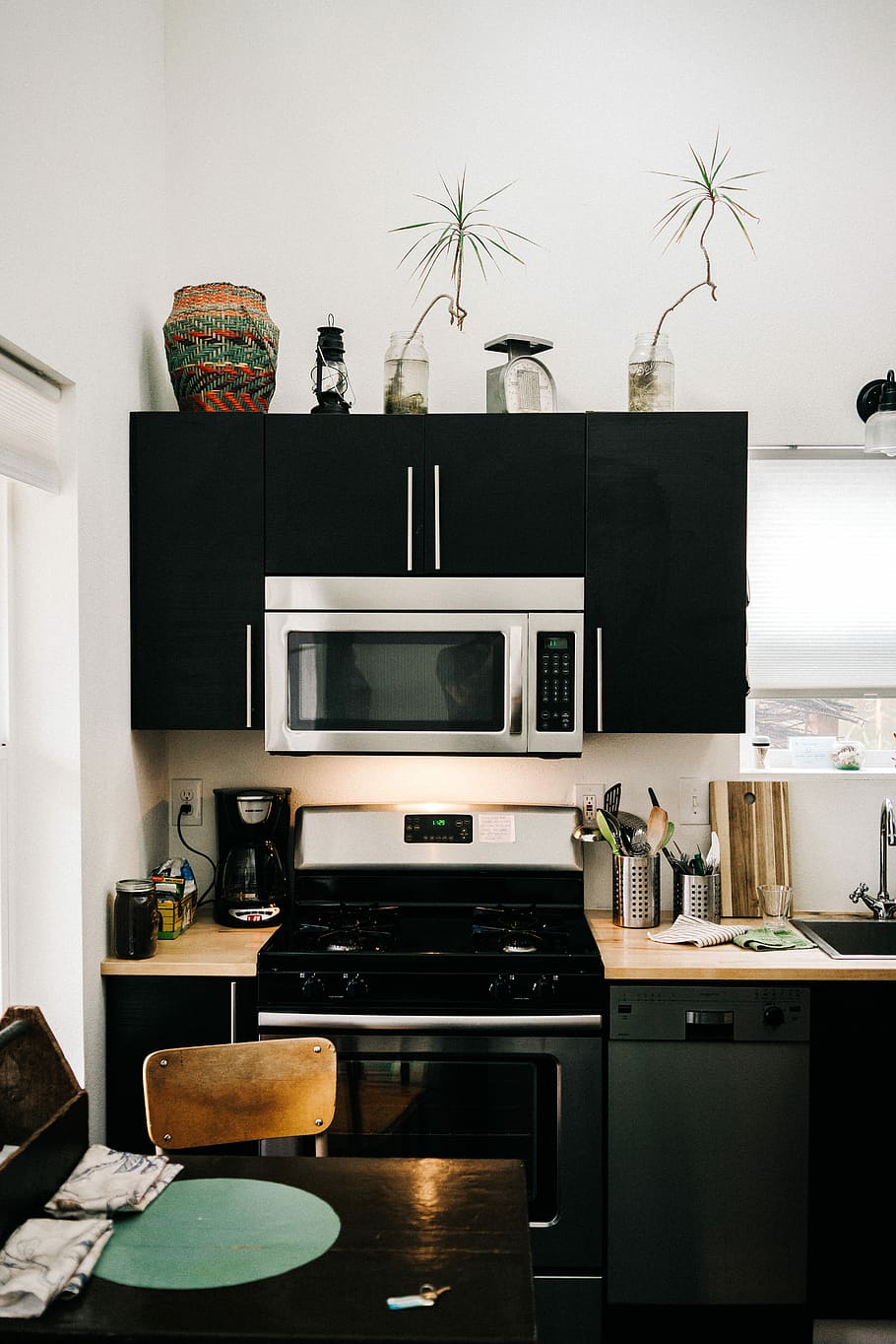 chair in front of range oven, kitchen isle and cupboard, microwave HD wallpaper