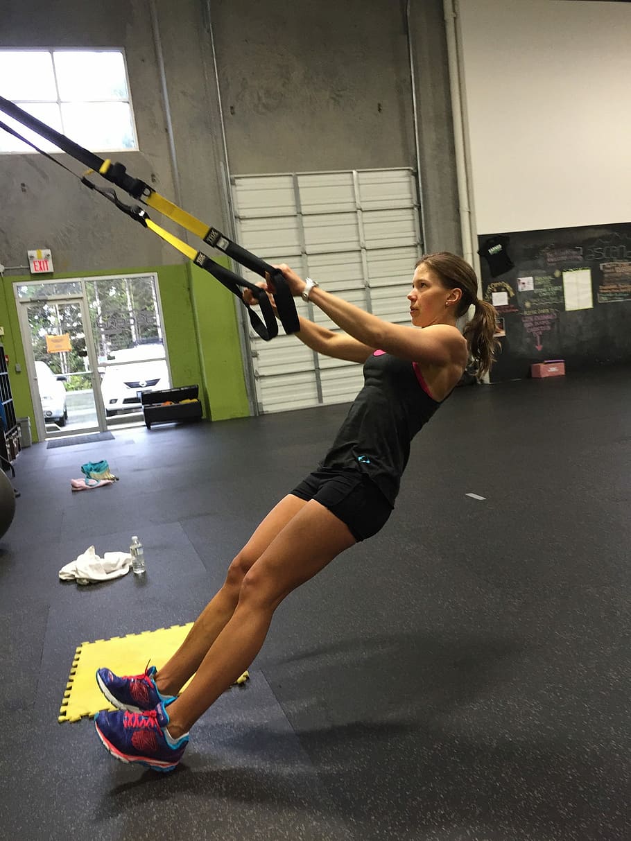 woman exercising using resistance band, Trx, Row, Workout, Fitness