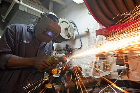 man wearing gray welding mask while grinding metal using angle grinder HD wallpaper