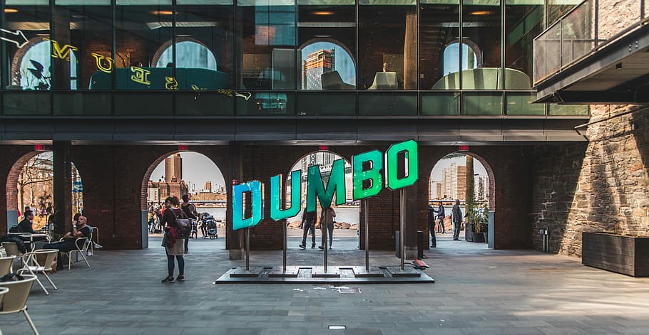 people walking near Dumbo signage, Dumbo signage near walking person near wall HD wallpaper