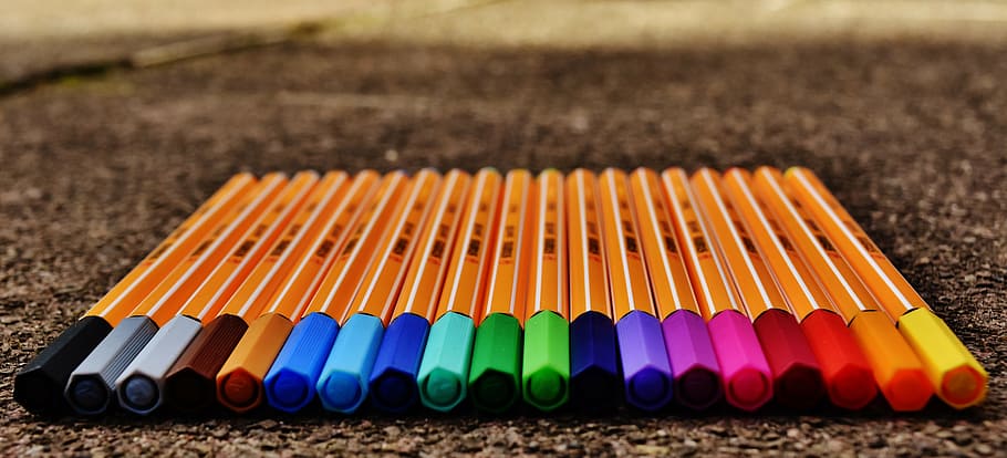 assorted-color color pen lot on black surface, pens, colour pencils