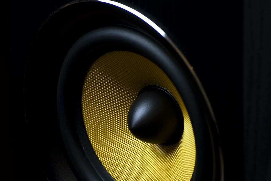 close-up photo of black subwoofer speaker, yellow, music, bass