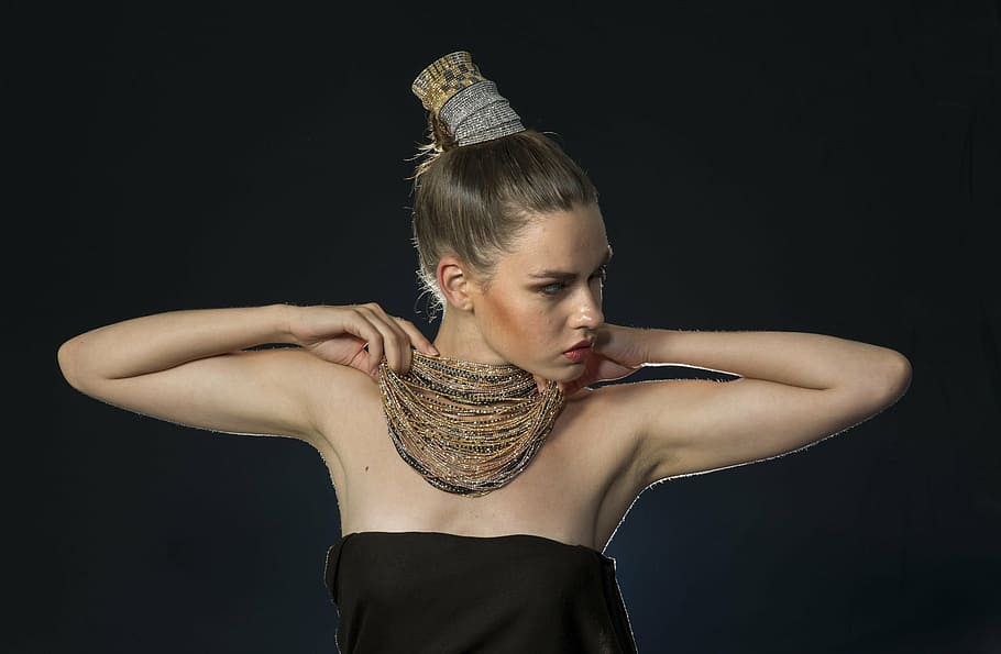 woman holding gold-colored necklace, model, fiction, exposure