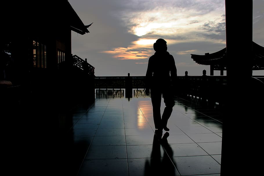 silhouette of person standing on floor, dark, sundown, vietnam
