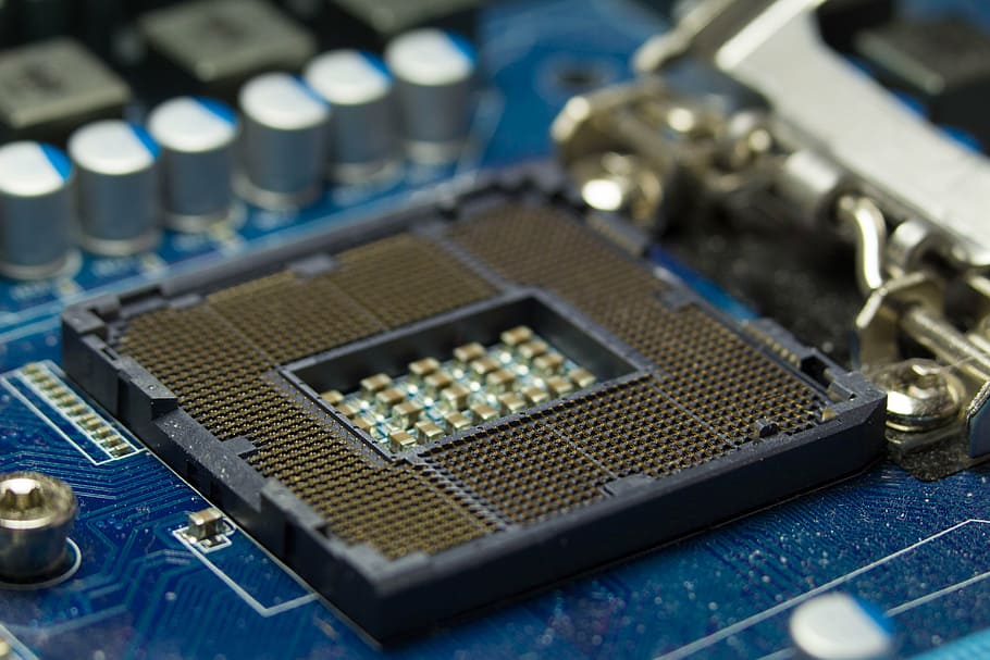 close-up photography of blue computer motherboard, cpu, soket