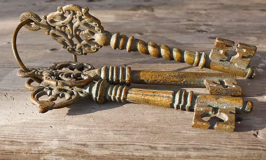 three brown skeleton keys on gray table, keychain, spears, close HD wallpaper