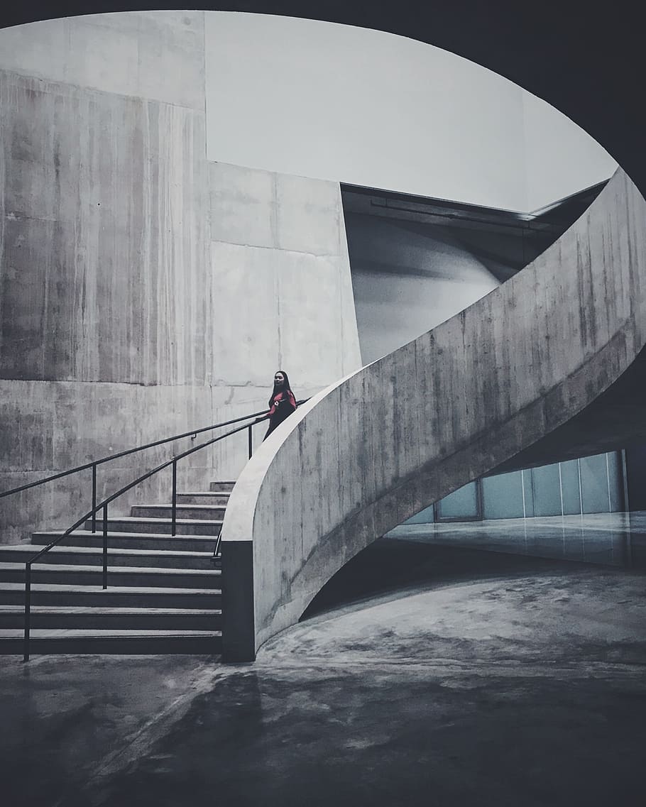 woman walking on stairs, woman in red top talking on concrete stairs inside building HD wallpaper