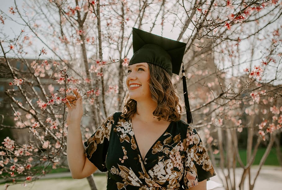 FSU graduation, woman standing in front pink leaved tree, one person, HD wallpaper