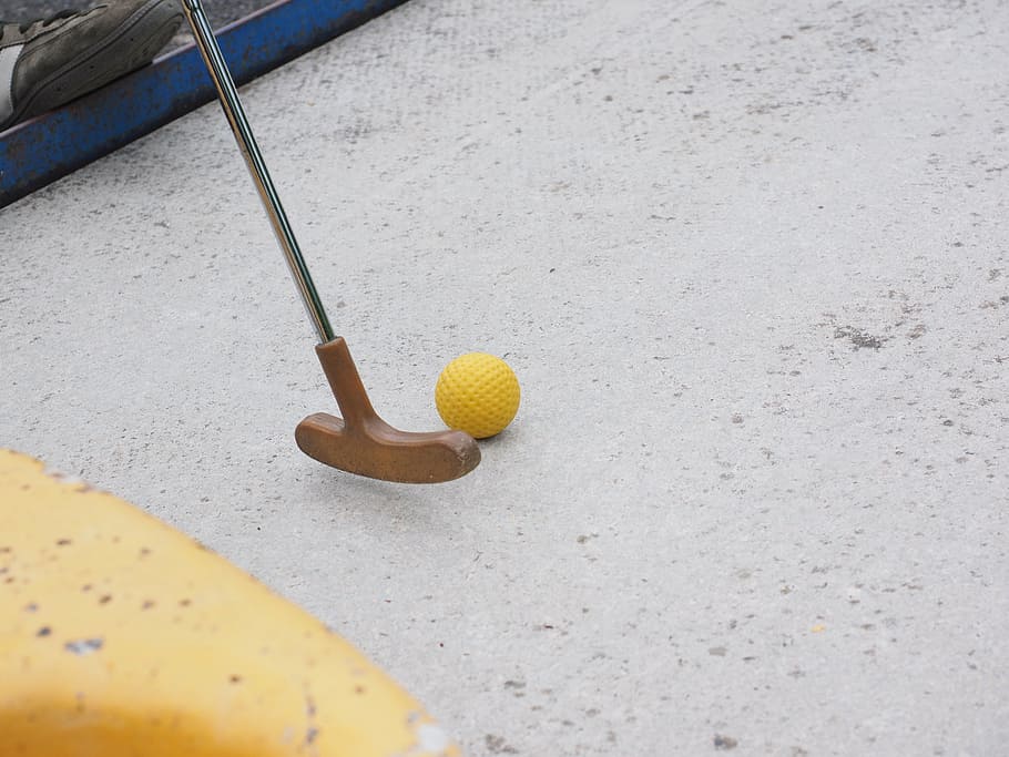 brown golf putter near yellow golf ball on white floor, mini golf club, HD wallpaper