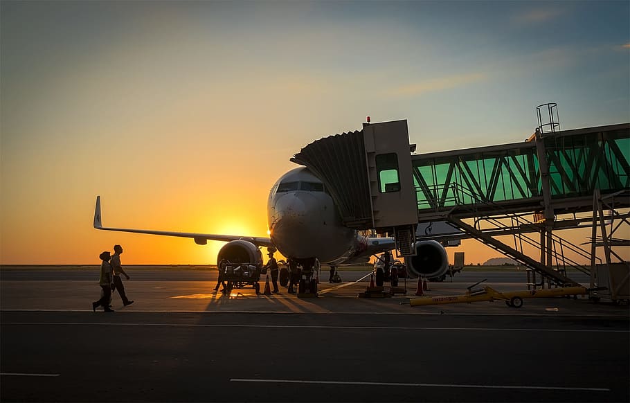 plane beside crane during golden hour, ramp, tarmac, concrete HD wallpaper