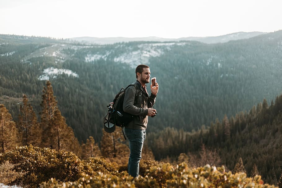 man wearing black jacket standing on mountain, person standing and looking HD wallpaper