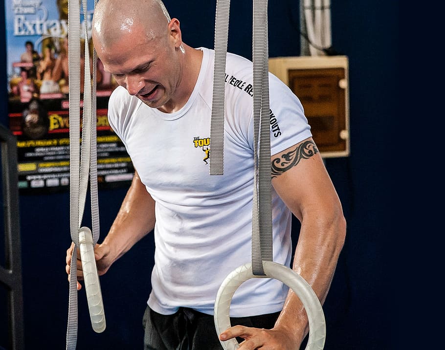 man holding round white handles, olympic rings, workout, training HD wallpaper