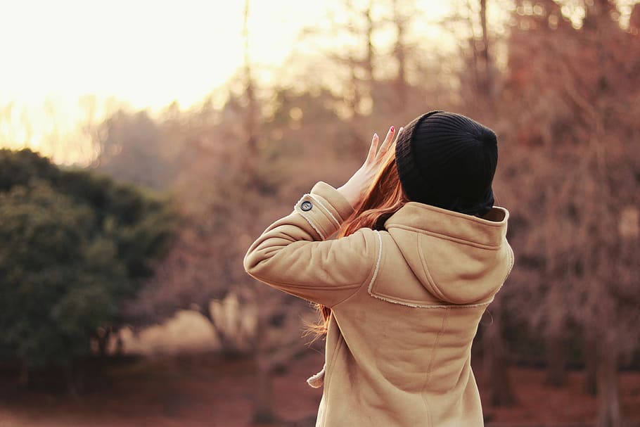 woman wearing brown jacket and black knit cap shouting near the trees during daytie, HD wallpaper