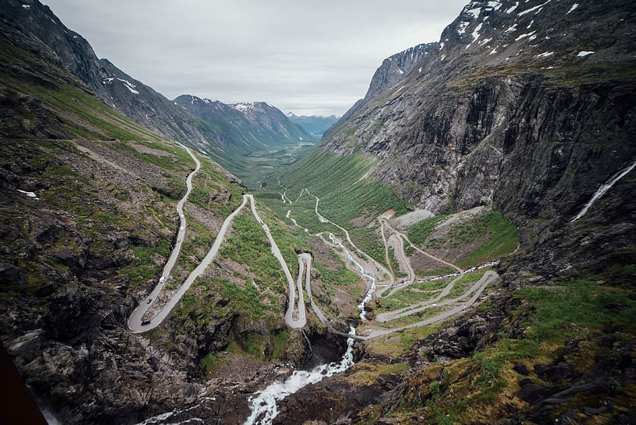 landscape of mountain, aerial view photography of road beside mountain during daytime HD wallpaper