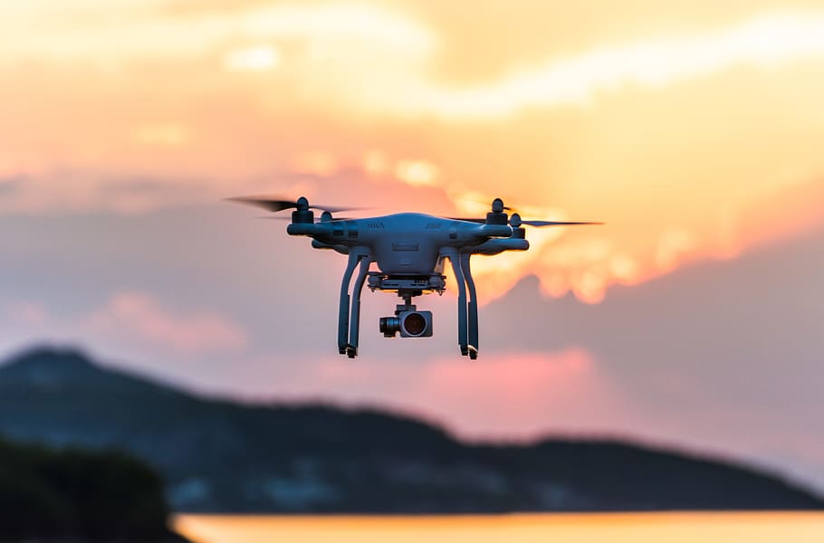 white quad-copter drone during golden hour, white drone with camera focus photography HD wallpaper