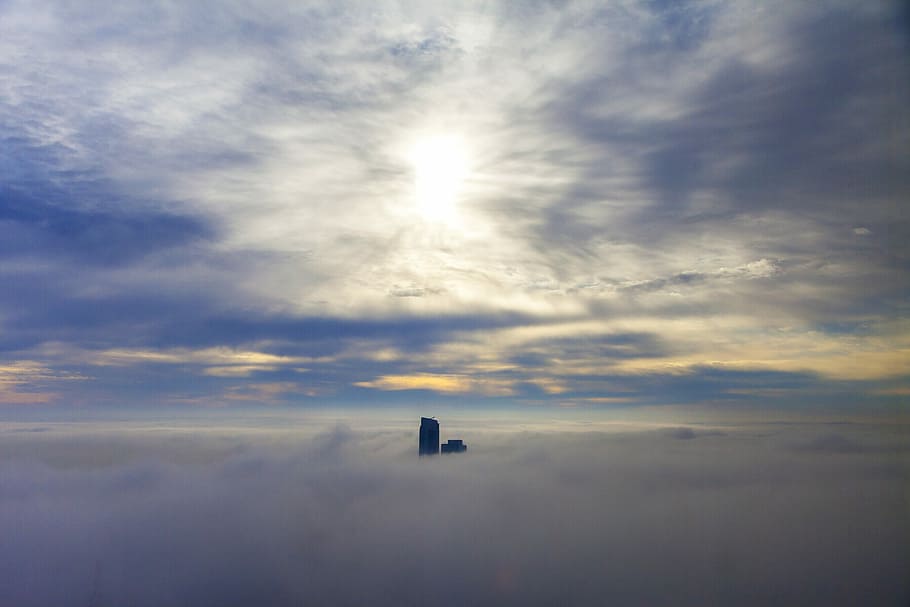 photo of black building surrounded by clouds during daytime, black building on white clouds under blue sky HD wallpaper