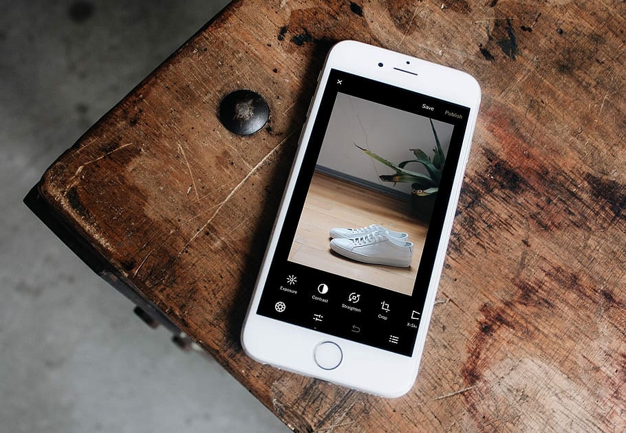 silver iPhone 6 displaying pair of white sneakers, silver iPhone 6 on brown wooden table HD wallpaper