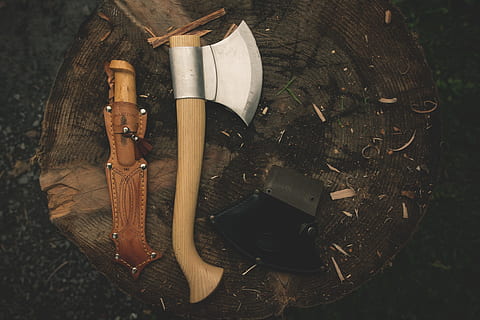 brown wooden handle throwing ax next to brown leather knife case HD wallpaper