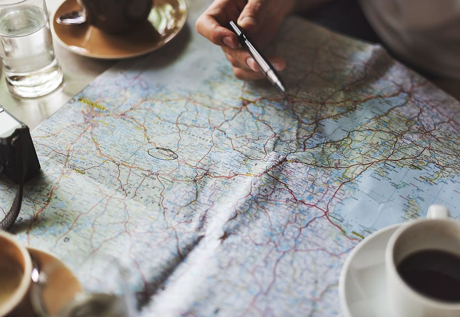 white teacup filled with coffee on map illustration poster HD wallpaper