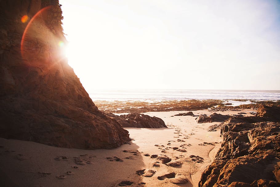 beach, footprints, rocks, sand, sunshine, sea, nature, sunset HD wallpaper