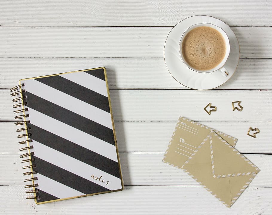 white and black striped notebook and white ceramic tea cup and saucer set, HD wallpaper
