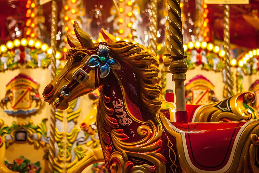 Brightly coloured fairground carousel horse, various, amusement