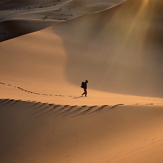 person walking in the desert, person walking on desert mountain ay daytime HD wallpaper