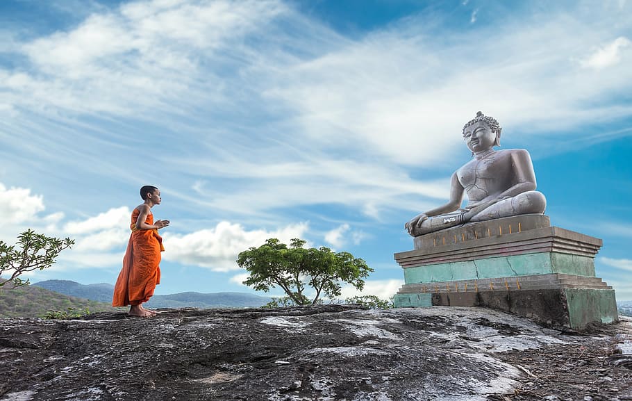 man praying in front of Gautama Buddha statue, ancient, architecture